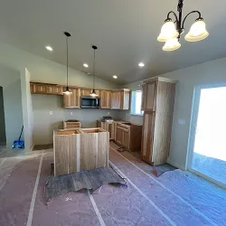 Kitchen under construction with unfinished cabinets